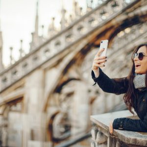 girl using her phone while exploring Milan Italy